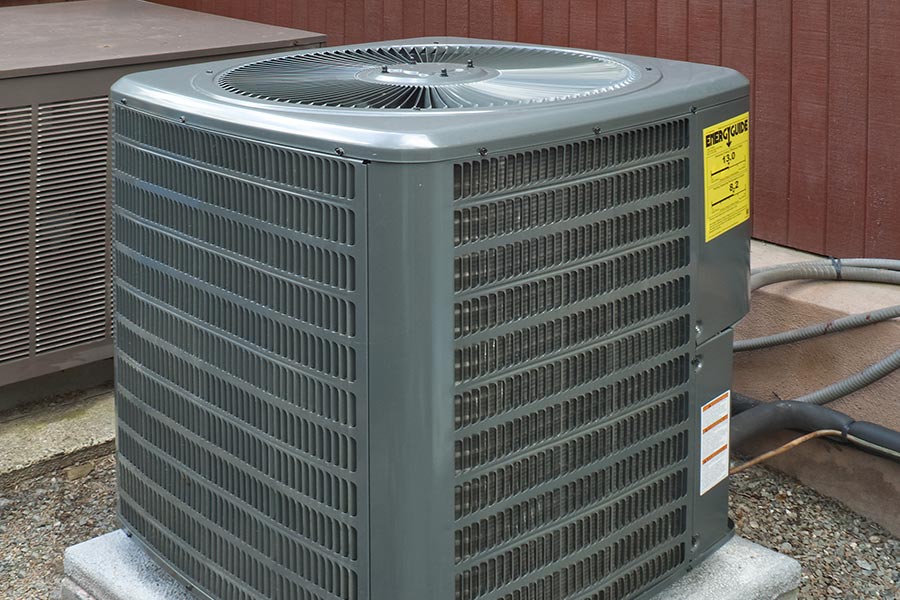 Outdoor air conditioning unit next to a house